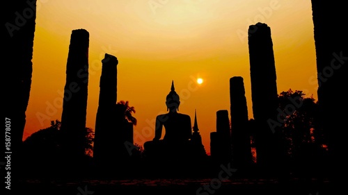 Sunset silhouettes of the Wat Mahathat Temple in Sukhothai Historical Park, Thailand, a UNESCO Heritage Site. 