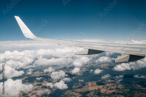 Wing of an airplane flying above the clouds