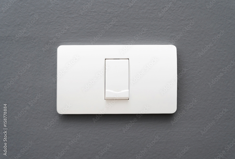 Light switch on gray concrete wall background. Light switch on gray concrete wall background.