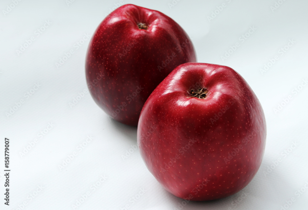two red apples on a light background two red apples on a light background