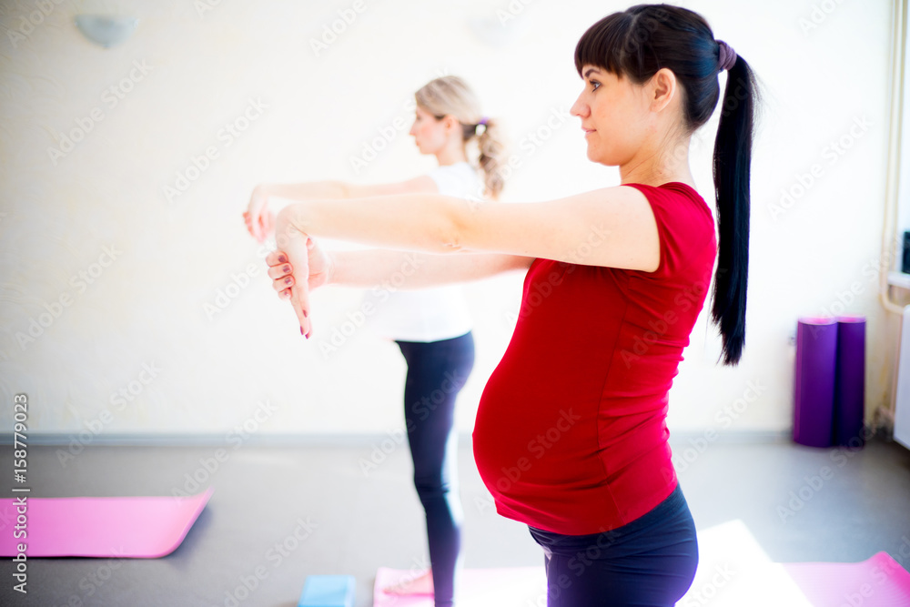 Pregnant woman does yoga exercises