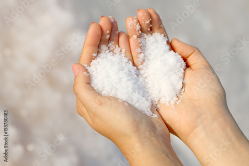 hand holding sea salt in the form of heart