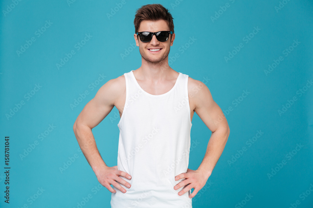 Young man in sunglasses posing isolated Young man in sunglasses posing isolated