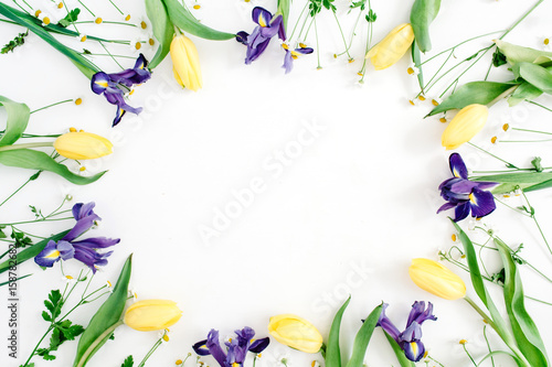 Fototapeta Naklejka Na Ścianę i Meble -  Round frame wreath with yellow tulips, purple iris and chamomile flowers on white background. Flat lay, top view. Floral background