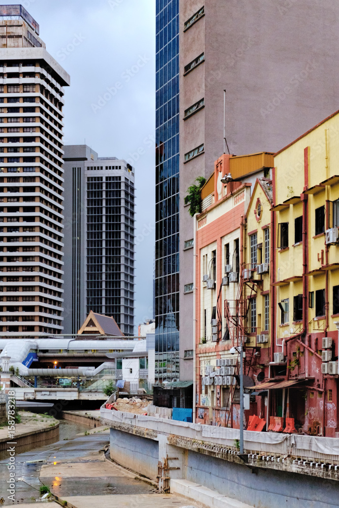 A mixture of styles of architecture in Kuala Lumpur, Malaysia. Cityscape with modern skyscrapers, office buildings and old houses