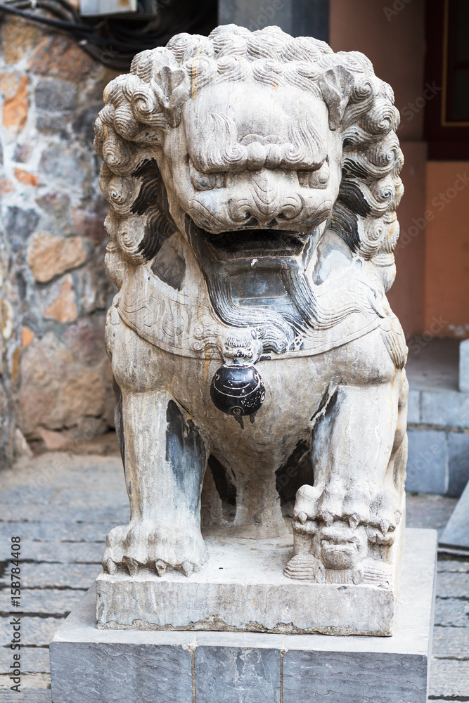stone lion statue near temple