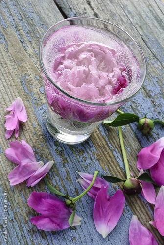 Petals of peony flowers scattered on a table