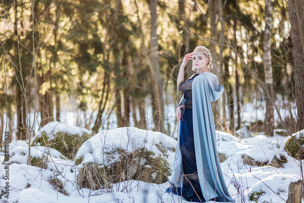 Fantasy elf girl in spring in a sunny forest Fantasy elf girl in spring in a sunny forest