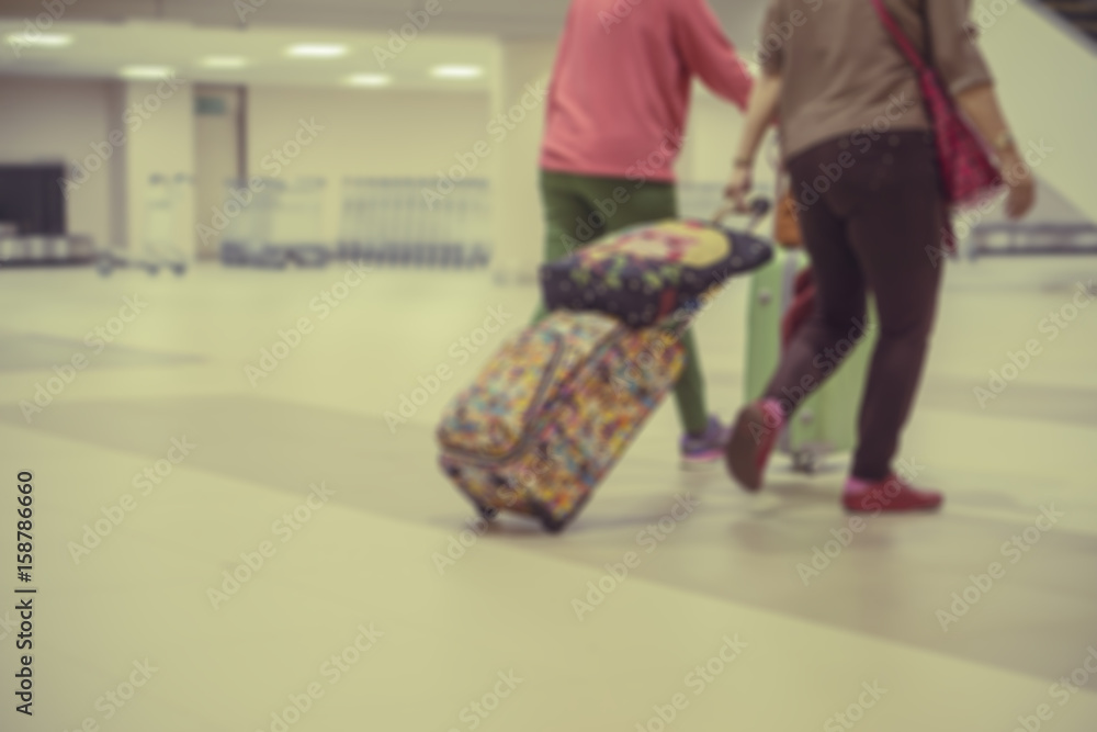 Blurred background of People walking in the airport,Airline passengers in the airport,passengers rushing at big city station. with retro filter effect,vintage color,