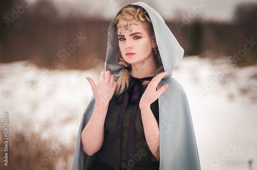 Fantasy elf girl in spring in a sunny forest