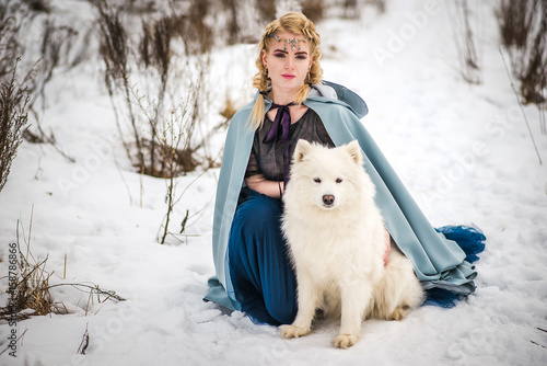 fantasy elf girl in spring forest with white dog laika