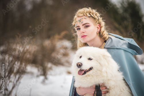 Fototapeta Naklejka Na Ścianę i Meble -  fantasy elf girl in spring forest with white dog laika