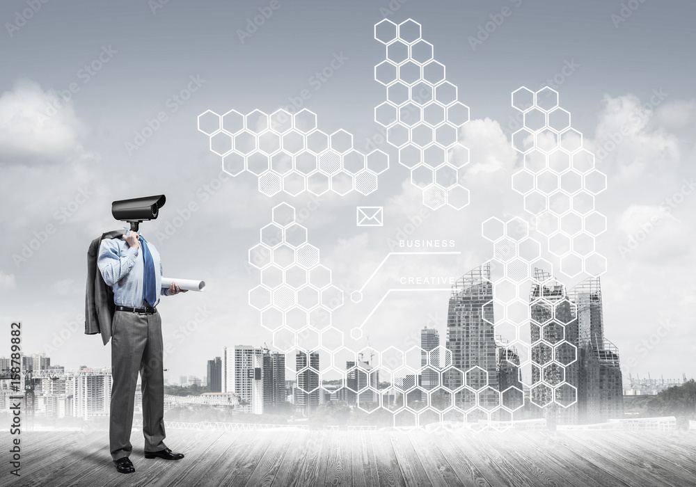Camera headed man standing on wooden floor against modern citysc Camera headed man standing on wooden floor against modern citysc