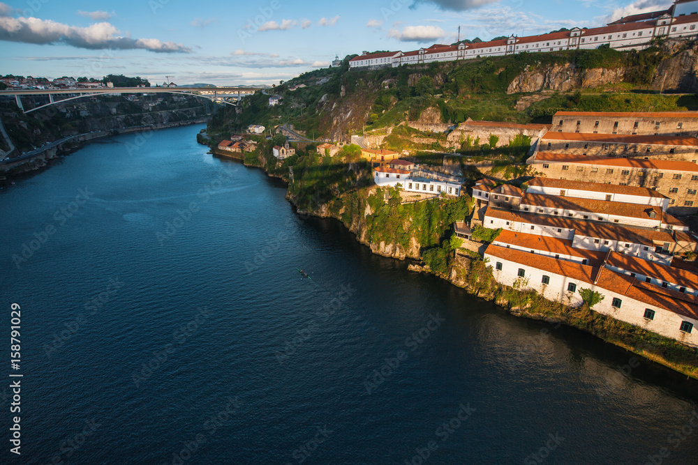 View of Douro river and the shore of Vila Nova de Gaia shot from Dom Luis I bridge, Porto, Portugal.