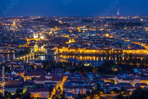 Prague at twilight blue hour, view of Charles Bridge on Vltava with Mala Strana and Old Town