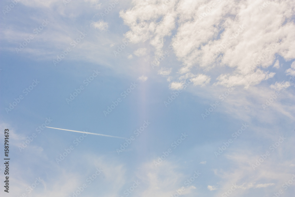 Jet smoke and blue sky with white clouds. Jet aircraft exhaust trail in sky. Jet smoke and blue sky with white clouds. Jet aircraft exhaust trail in sky.