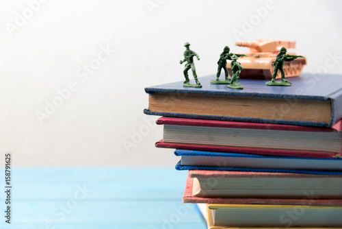 soldier toys on stack of book