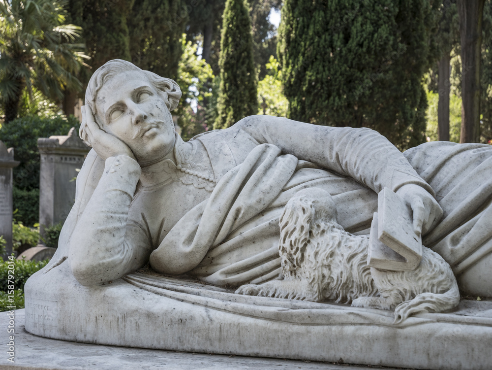 Sculpture of a lying man with a book in his hand and a dog. Protestant Cemetery in Rome