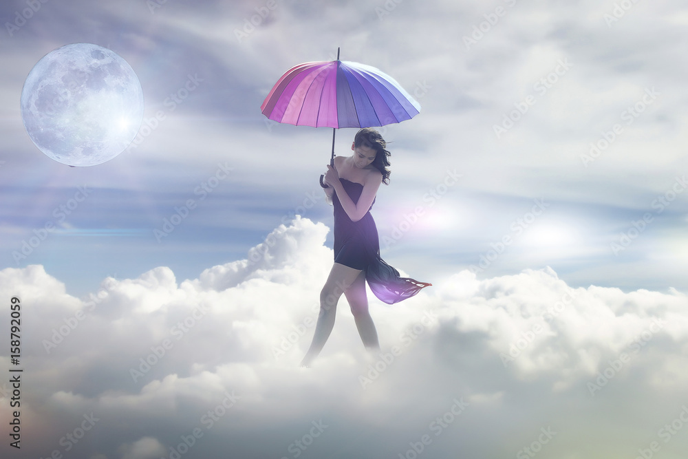 Beautiful collage with an ancient turkish style woman walking in the clouds. woman walking in the clouds with umbrella 
