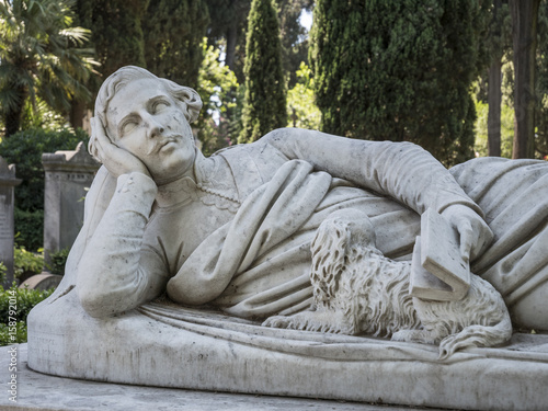 Photography Sculpture of a lying man with a book in his hand and a dog