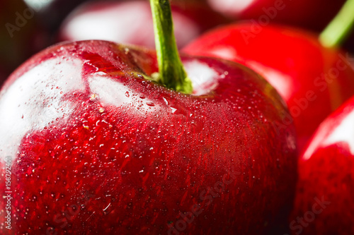 Fresh and wet cherry berries with water drops, macro image, selective focus