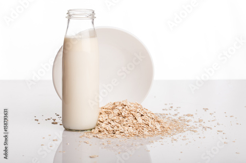 Flakes and milk on a white background