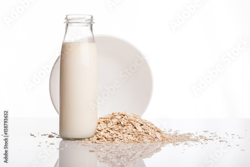 Flakes and milk on a white background