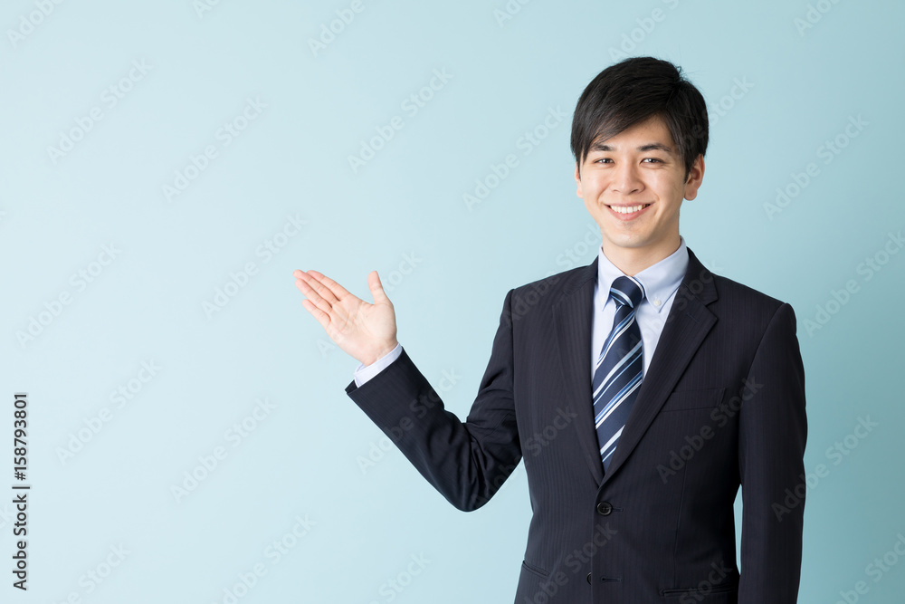 portrait of asian businessman indicating isolated on blue background portrait of asian businessman indicating isolated on blue background