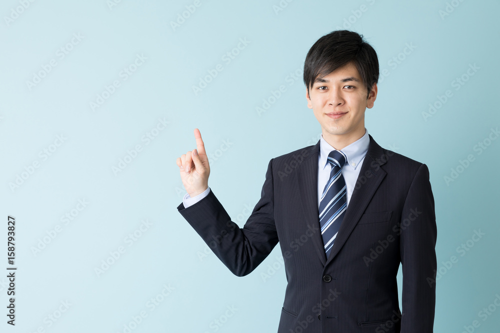 portrait of asian businessman indicating isolated on blue background portrait of asian businessman indicating isolated on blue background