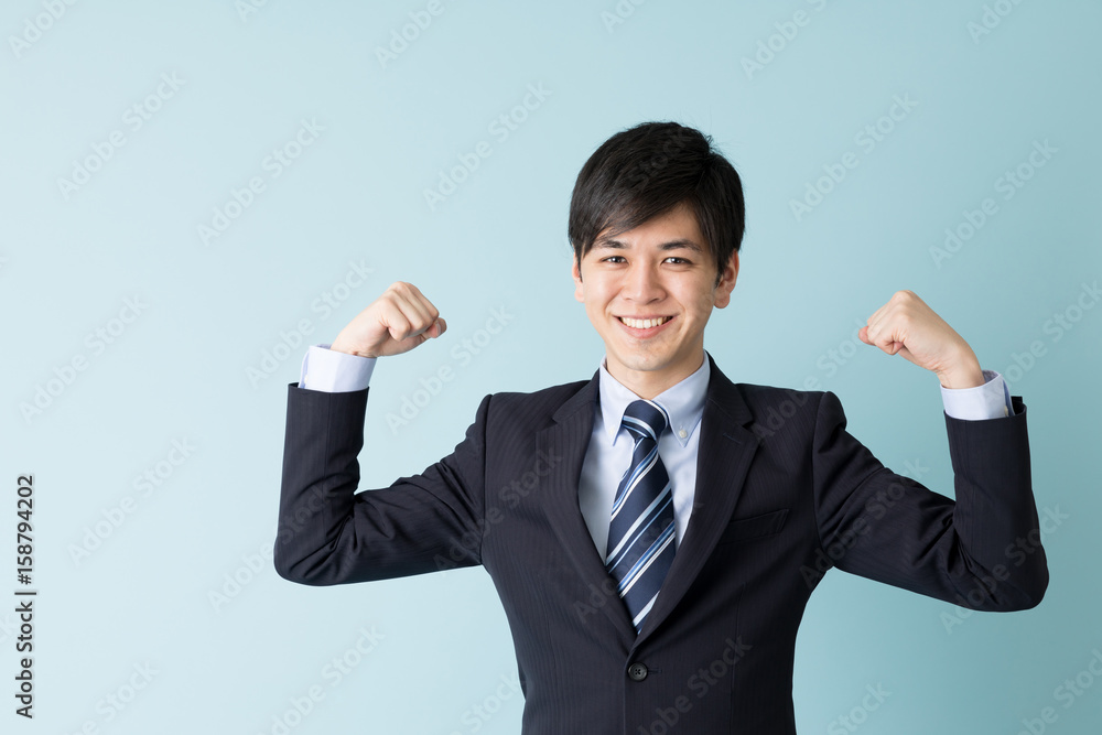 portrait of asian businessman isolated on blue background portrait of asian businessman isolated on blue background