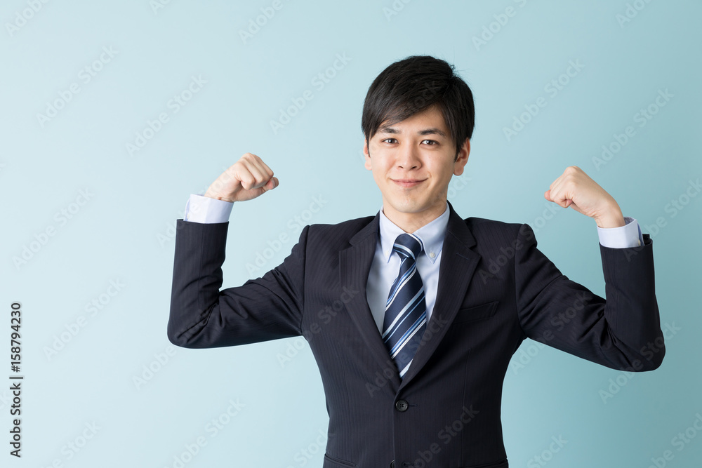 portrait of asian businessman isolated on blue background portrait of asian businessman isolated on blue background