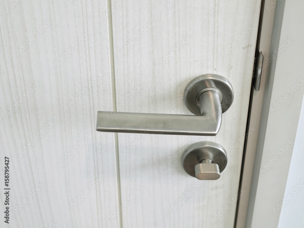 Door handle with lock on the white door, closeup. Concept of interior design modern room. Door handle with lock on the white door, closeup. Concept of interior design modern room.
