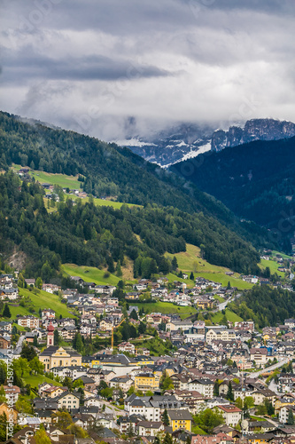 Wallpaper Mural Looking towards the stunning Alpine mountain of Ortisei with blue sky and white clouds, an awesome view of the beautiful Dolomites can be seen in the distance, Northern Italy, Europe Torontodigital.ca