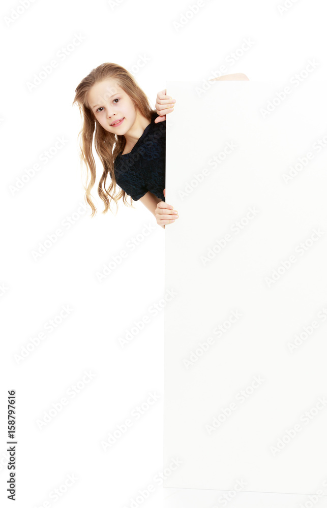 The girl peeks out from behind the banner. The girl peeks out from behind the banner.