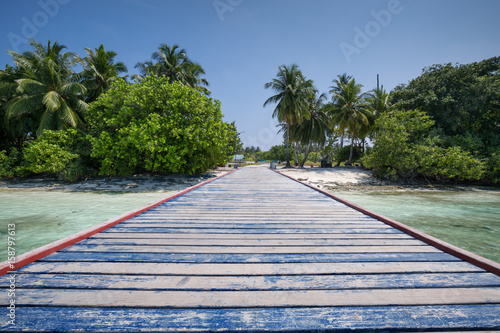 Fototapeta Naklejka Na Ścianę i Meble -  Tropical travel destinations with Maldives island and wooden wharf