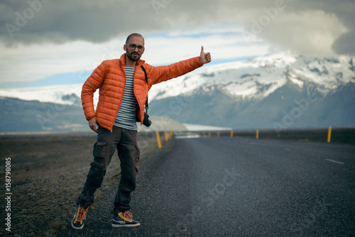 Travel hitchhiker man on a road