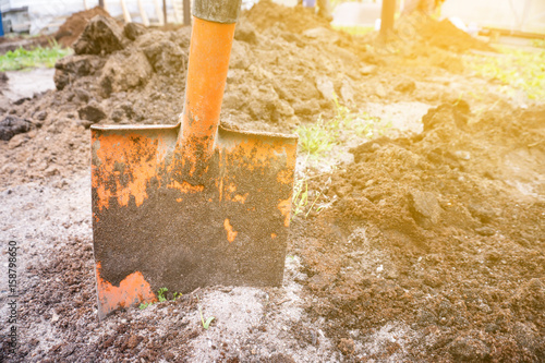 Dirty shovel dig in sand