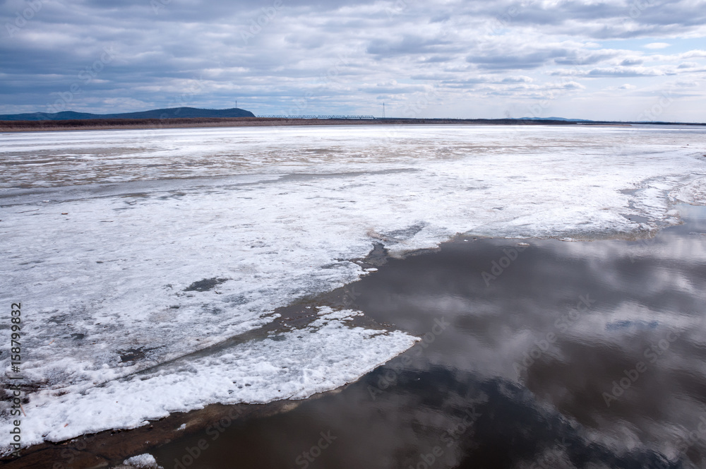 Amur River under the ice, embankment of Komsomolsk-on-Amur
