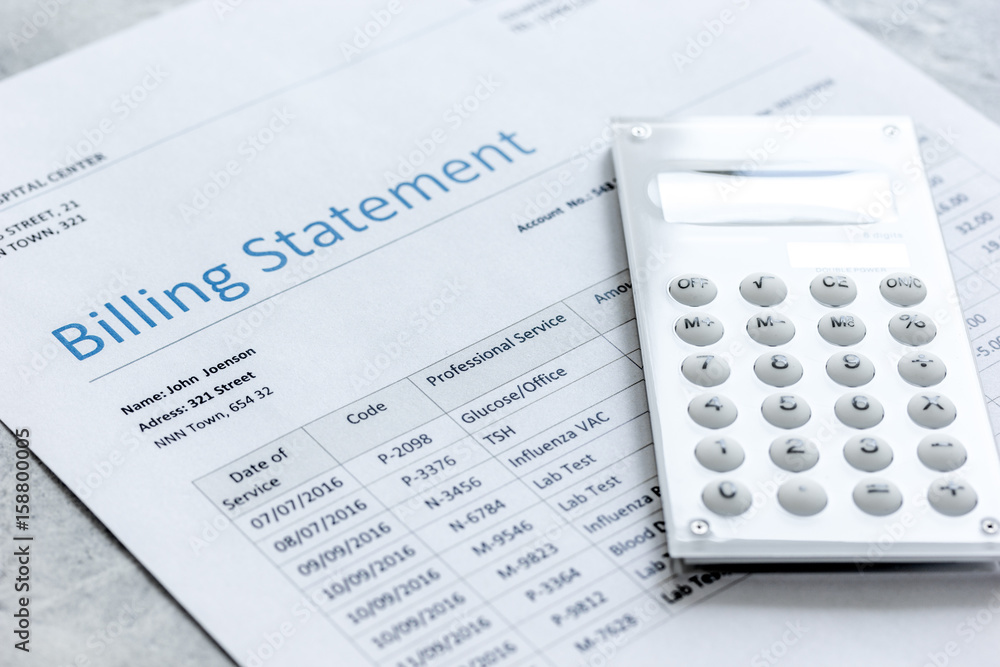 calculator, billing statement for doctor's work in medical center stone background calculator, billing statement for doctor's work in medical center stone background