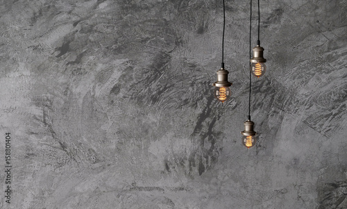Industrial pendant lamps against a rough concrete wall. The interior of the loft style. Edison light bulbs.