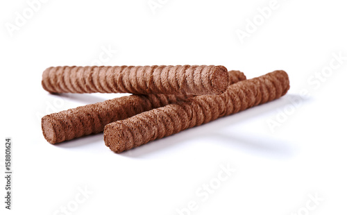 Chocolate wafer rolls with butter and cocoa filling on a white background