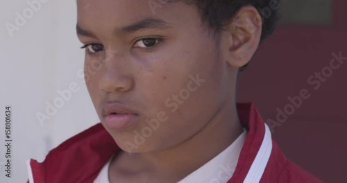 Sad boy in jacket, close up