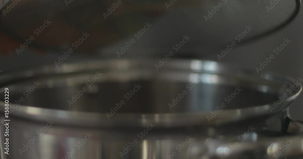 Cook lifts lid off soup pot Cook lifts lid off soup pot