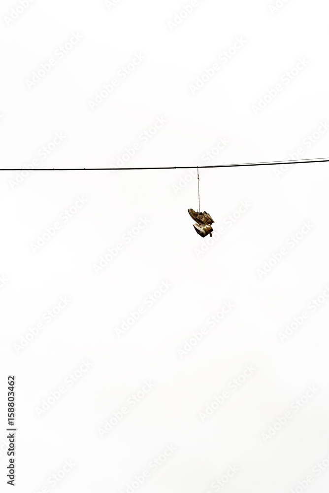 Fototapeta premium Boots Hanging on Electricty Cable