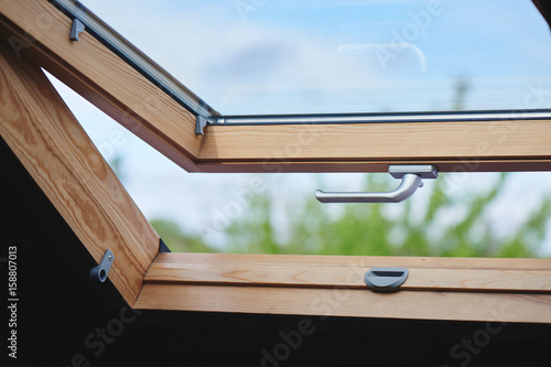 Open wooden window with silver handle