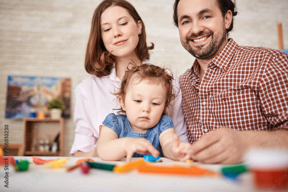 Portrait of happy family playing with cute toddler girl at home Portrait of happy family playing with cute toddler girl at home