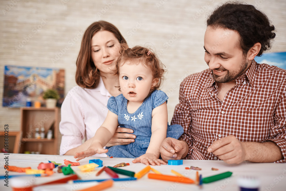 Portrait of happy family having fun playing with cute little daughter at home Portrait of happy family having fun playing with cute little daughter at home
