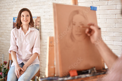 Bild auf Leinwand Portrait of artist drawing  portrait of beautiful young woman sitting in front o
