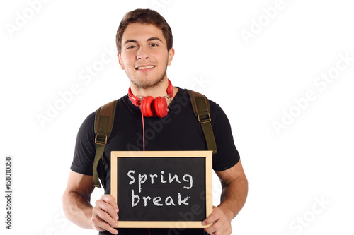 Man holding chalkboard with "spring break".