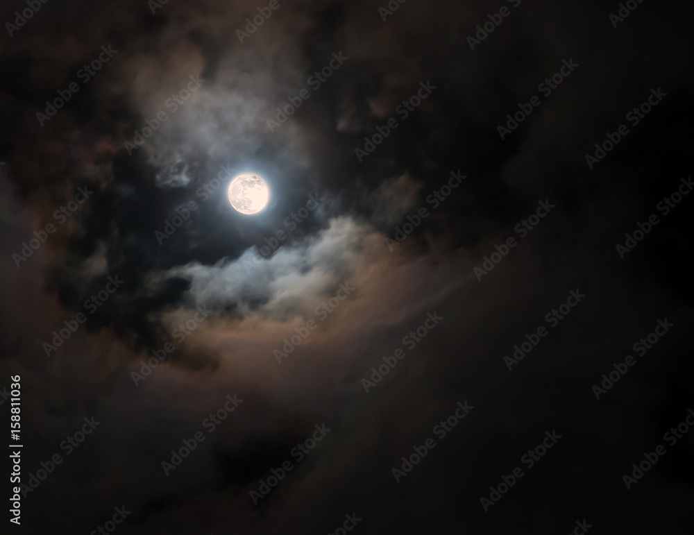 Full Moon among colorful swirling clouds Full Moon among colorful swirling clouds